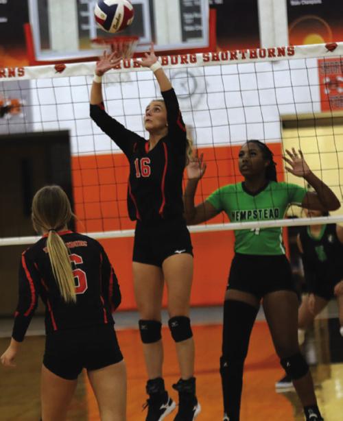 Schulenburg’s Jenna Guentert sets a ball in Friday’s victory over Hempstead. Photo by Audrey Kristynik