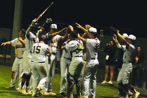 The players in the dugout come out to greet La Grange’s Landon Little after he scored a run Tuesday’s game against Smithville. Photos by Jeff Wick