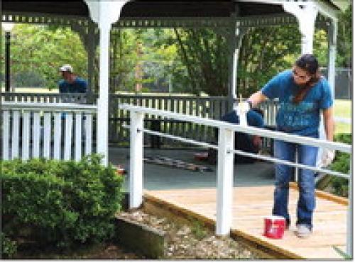 An LCRA employee paints the gazebo railing at Mc-Whirter Park in Flatonia during LCRA’s Steps Forward Day on April 14.