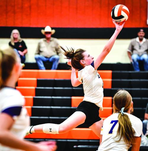 La Grange’s Hailey Hill tips the ball over in Tuesday’s match against Smithville.
