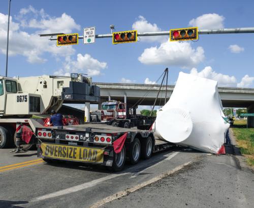 A big rig that turned from the Highway 71 Bypass north onto SH 159 lost its load near the 71 overpass in La Grange on Thursday. The load was a 75,000 lb. piece of air conditioning equipment, pictured above wrapped in white plastic. Photo by Andy Behlen