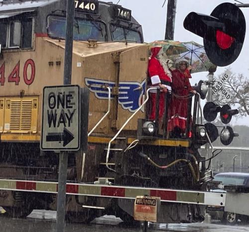 Santa and Mrs. Claus made an early stop in La Grange Saturday on the front of a train (in a rainstorm!) and then disembarked to visit with kids at the MKT Depot Museum.