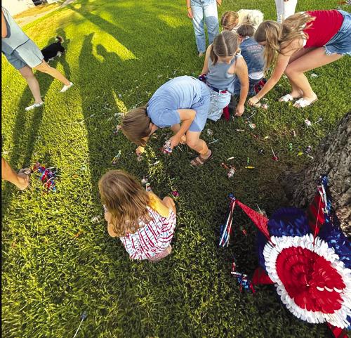 Playing with a pinata on the square during July 3 festivities. Photo by Morgan Zator