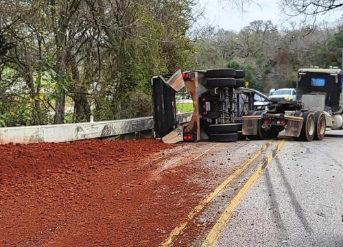 An 18-wheeler loaded with gravel rolled over on the Bluff Monday, precipitating an hours-long traffic jam in La Grange. Photo courtesy of the Fayette County Sheriff’s Office