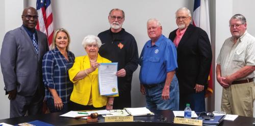 The Schulenburg City Council signed a proclamation Monday night, June 6, honoring legendary women’s basketball coach Larry Tidwell for his long successful career and recent induction into the Texas High School Basketball Hall of Fame. Pictured are (from left): Alderman Greg “Wolf” Thomas, Alderman Wendy Fietsam, Mayor Elaine Kocian, Tidwell, Alderman Larry Veselka, Alderman Howard Stoner and Alderman Clarence Ahlschlager. Photo by Andy Behlen