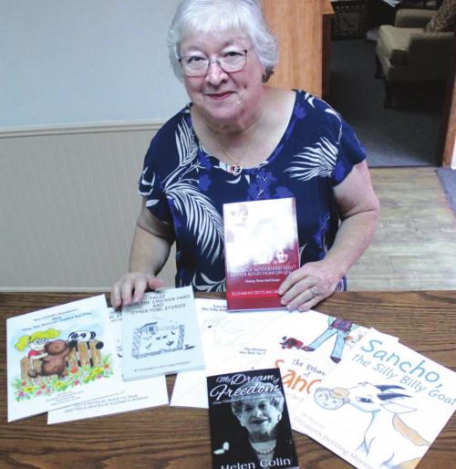 Elizabeth Dettling Moreno with several of the books she has written.