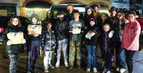 Feed the Need Mission of La Grange teamed up with youth volunteers from Fayette County 4-H to distribute about 200 turkeys and “gobble kits” on the Courthouse Square in La Grange on Monday, Nov. 21. Photo by Andy Behlen