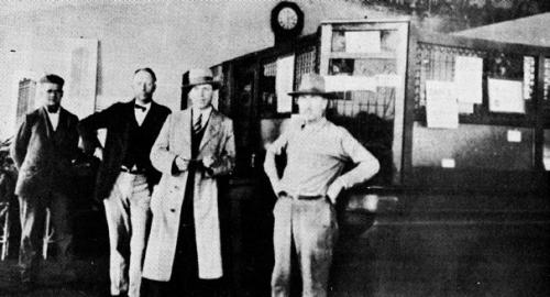 Interior of Carmine State Bank. From left, the men are William Pluekhahn, H. L. F. Doerr, Sr., Alfred Blum and W. H. Stuermer. Photo from the March 4, 1986 issue of the Fayette County Record.