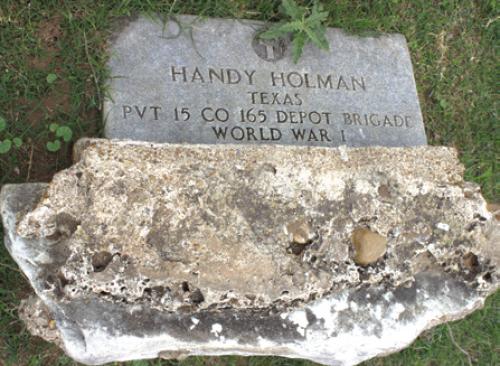 Handy Holman turned over headstone. Photo courtesy of the Hills.