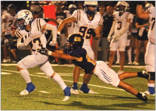 La Grange’s Tye Johnson makes a diving try to stop Lago Vista’s Wyatt Herring, who rushed for 302 yards and three touchdowns in Friday’s 35-20 victory over the Leopards. Photo by Jeff Wick
