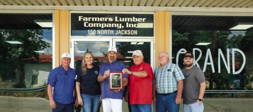 Farmers Lumber Company (FLC) held a grand re-opening celebration at their historic storefront on Jackson St. last Thursday. Pictured (from left) are general contractor Jeremy Conard of Conard Construction, Velvet Phillips of the distribution company Gaiennie Lumber, FLC General Manager Walt Jackson, FLC President Herb Janssen, FLC Vice President Harry Lehmann and Jacob Meadows of WindsorOne. Photos by Andy Behlen