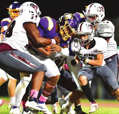 Devon Walles and Titan Targac stop a Weimar Wildcat from gaining yardage in Friday night’s district matchup. Photo by Stephanie Steinhauser