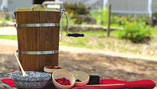 An old-fashioned ice cream tub, along with some toppings, sits in front of the Kreische Home at the state historic site above La Grange.