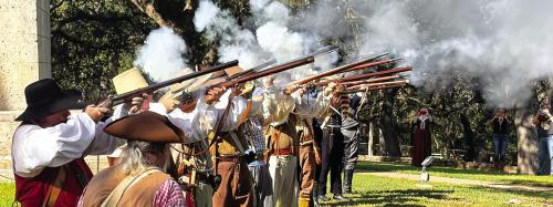 Texan Army Reenactors fired a three-volley salute to honor the men from the Dawson Massacre and Mier Expedition Saturday atop Monument Hill in La Grange. Photo by Andy Behlen