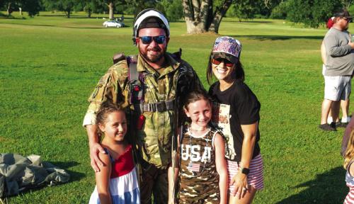 Local veteran and U.S. Army Paratrooper Dustin Blackwell jumped with the skydivers. He’s pictured here on the course after the landing with his wife Kelly and their children. Photos by Andy Behlen
