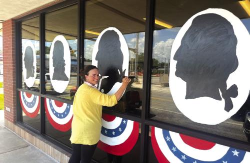 In honor of America’s 250th birthday this summer local businesses have been putting a little extra red, white and blue into their decorating. Above, local artist Bonnie Karstedt was hard at work on a massive art piece at Fayette Savings in La Grange that the bank plans to keep up into September. The area shown above is just one-fourth of the area Karstedt was painting. Photo by Jeff Wick