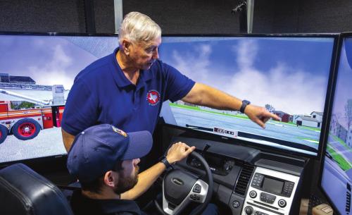 Don Courtney, a driving simulator consultant with the Texas Association of Counties, instructs Fayette County EMS medic Justin Laslie in safe driving techniques on Tuesday, Feb. 1. Photo by Andy Behlen