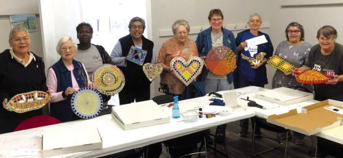 Nine members were present on Mosaic Mania photo day and they are from left: Polly Quinones, Helen McIntyre, Alfreda Ellison, Cindy Villarreal, our Director, Irene Janda, Berni Gillings, Mary Bellinger, Carolyn Moore, and JoNell Vacek show off their mosaic pieces of art.