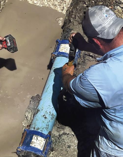 A man works to repair the water line Thursday in Fayetteville.