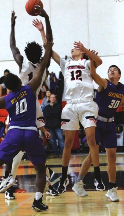 Schulenburg’s Keanu Anthony and Kael Baumgarten try to get this loose ball Friday. Photos by Audrey Kristynik