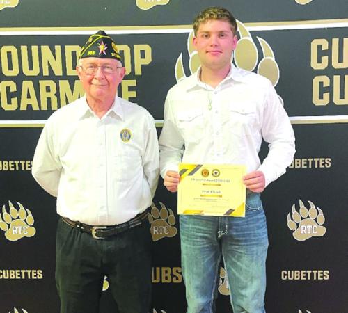 Frank Williams, Financial Officer of American Legion Post No. 338 presents the Citizenship Award and Scholarship to Evan Blazek of Round Top-Carmine High School.