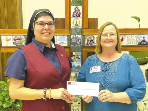 St. Rose of Lima Catholic School’s Change for Change Lenten Service Project raised $1,400. Sister Maria del Rosario Resendez is shown receiving the donation from Principal Rosanne Gallia. The donation benefits the Sisters of Incarnate Word and Blessed Sacrament Mission in Africa and Promise Point in Victoria.