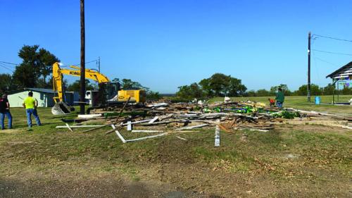 The old German Czech Mart came down at the Fairgrounds Tuesday morning, Oct. 9. Workers removed the tin from the roof last week. Joe Rogers Dozer Service was on site Tuesday morning to demolish the rest of the structure.