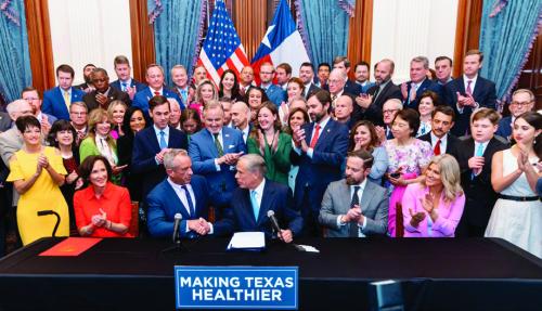 Governor Greg Abbott (front, center) shakes hands with U.S. Secretary of Health and Human Services Robert F. Kennedy, Jr., upon signing Senate Bill 25. The bill was authored by State Senator Lois Kolkhorst (pictured to the left of Kennedy). Kolkhorst represents Fayette County in the Texas Senate.