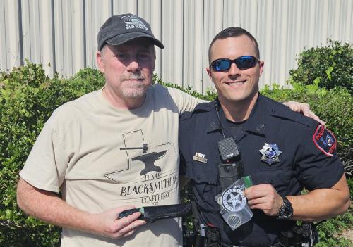 La Grange Patrol Officer Mitchell Maxwell (right) will be named an Officer of the Year by The 100 Club for saving the life of fellow officer Kevin Currington (left). Currington, who is also a blacksmith, is pictured here presenting Maxwell with a knife he made earlier this year