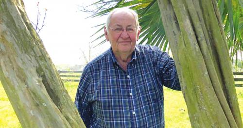 Cordell Levien of Round Top is framed by timeworn trunks of a crepe myrtle planted by his parents nearly a century ago. In the late 1930s, Cordell recalls traveling to La Grange with his father, Alfred. When Mr. Levien stopped to see his friends in the courthouse, they asked if the youngster he had by the hand was his grandson. “No,” Alfred proudly told the sheriff and the judge, “This is my youngest son, Cordell.” 