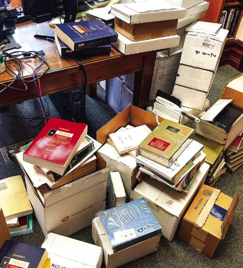 A jumble of mostly unopened or unwrapped boxes of law books (some dating back years) fill the floor of the county Law Library in the courthouse when we visited Friday. Photo by Andy Behlen