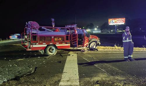 Two Carmine firefighters suffered injuries and their fire truck was totaled following a wreck on US 290 near Burton Sunday.