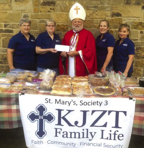 St. Nicholas (aka Pastor Herb Beyer) with members St. Mary’s KJZT Society at one of its fundraisers helping provide for needy families.