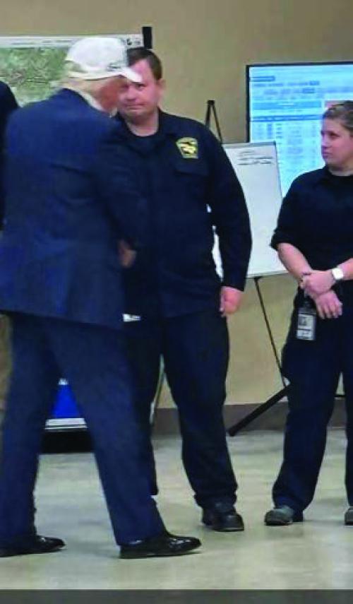 Fayette County EMS Director Josh Vandever, center, shakes hands with President Donald Trump during his visit to Kerrville Friday.