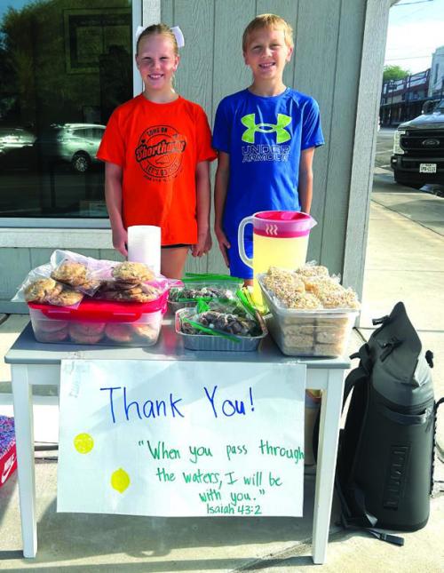 Kase Bubela, 11, right, and his cousin Chandler Bubela, 9, left, spent two days last week in front of Anytime Fitness on North Main St. in Schulenburg selling treats and lemonade to raise money to help the people devastated by the flooding in the Hill Country on July 4. The first day the Bubelas made close to $500, said their grandfather, Kenneth Kocurek, who made a bunch of rice krispy treats to restock their stand for Day 2. In all, the kids raised over $1,100. Photo by Kenneth Kocurek