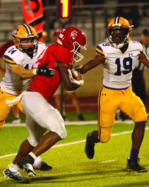 La Grange’s Clayton Kanpik (14) and Phillip Arceneaux (19) corral Columbus ballcarrier JJ Hurd in last Friday’s game. Photo by Darrell D. Gest