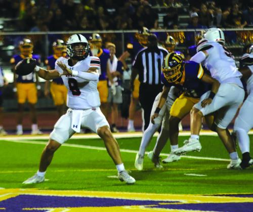 Schulenburg quarterback Owen Brenek looks to make a pass Friday as a Weimar player tries to get through the Shorthorn line to apply pressure. Photo by Audrey Kristynik