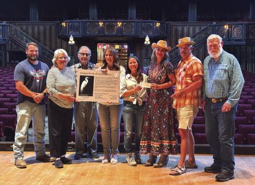 Accepting the check on the Concert Hall stage are RTFI Staff members Chris Johnson, Pat Johnson, James Dick - Founder and Artistic Director; artist Elen Hart, RTFI Horticulturalist Julie Johnson, Crown Bar owners Beth Weishuhn, Andy Johnson, and Larry Weishuhn
