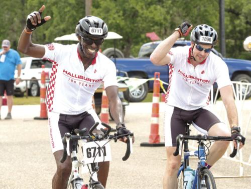 Cyclists celebrate at they arrive at the midway point of the MS 150 ride in La Grange.