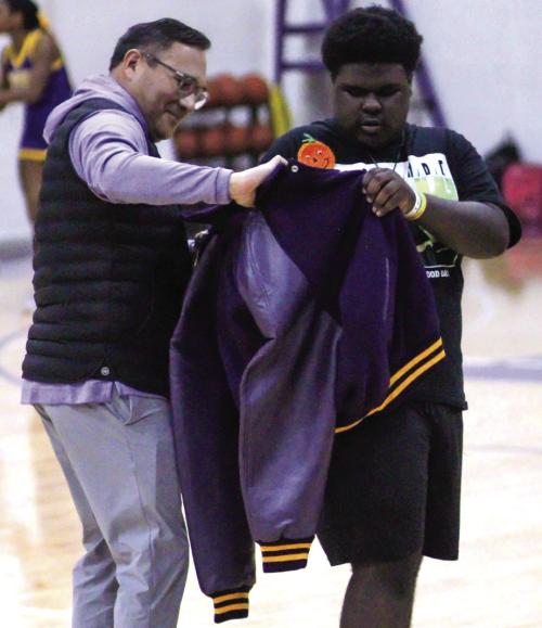 La Grange High School student Curtis Smith, right, was presented a special letterman jacket by principal John Pineda, left, during a pep rally last week. Photo by Lila Glaiser, Leopard Spots Yearbook