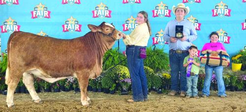 Grand Champion Heifer: Rheagan Karisch, Rilan Karisch, holding buckle, Carson and Aubrey Neumann, holding awards.