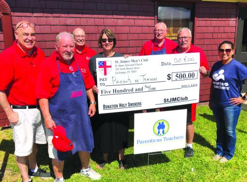 The Holy Smokers’ cooked for Parents as Teachers Saturday, Oct. 8. Pictured from left to right: Father Chris Heying, Mike Parrish, Dr. Bill Bailey, Sherise Davis (PAT), Ed Dykes, Jim Malik, and Gina Martinez (PAT).