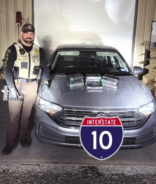 Deputy Cody Williams pictured with the cocaine seizure.