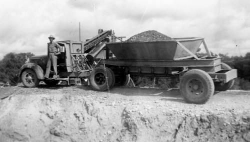 Photograph of an unidentified man standing on the running board of a gravel truck. Photo courtesy of the Fayette Heritage Museum and Archives