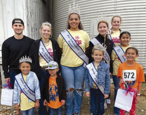 Pictured are 5K winners Laine Brown (on the far left in the dark sweatshirt) and Emma Zweschper (on the far right in the front row). They are pictured with Schulenburg Festival royalty, who volunteered to work the water station at the halfway mark of the 5K.