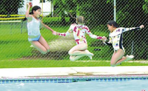 Kids jump into the La Grange city pool on Opening Day 2023, the last year the pool was open. Record file photo
