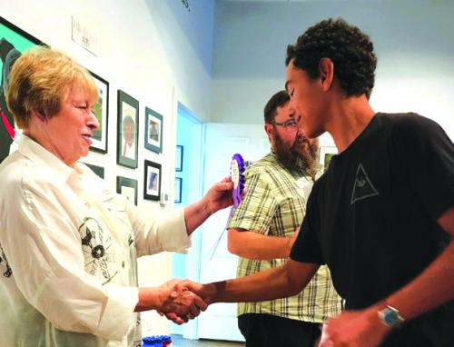Karen Vernon, ARTS Executive Director, congratulating Phoenix Kooper, 2022 Best of Show Winner.