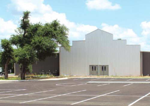 The worship center at the new First Baptist Church location is still under construction, but services will be held on the site for the first time this Sunday. Note the trees in the left of the photo, still snarled by damage from last year’s tornado. Photo by Jeff Wick