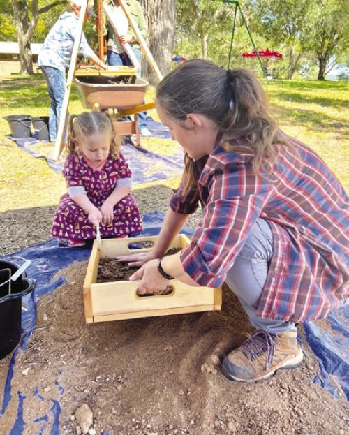 Texas Historical Commission staff and local families sift for archeological artifacts at Archeology Day’s mock excavation.