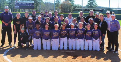 The members of the La Grange varsity and the alumni squad pose together after their annual scrimmage Saturday. Photo by Jeff Wick